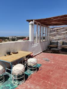 a patio with a table and chairs on a patio at Hippie Chic Room 3 in Sidi Kaouki