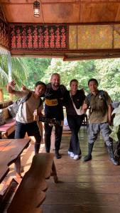 a group of people posing for a picture at Aussie Inn Bukit Lawang in Bukit Lawang