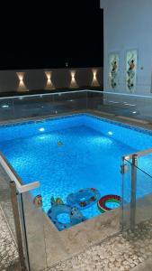 a large swimming pool in a building with at Monsoon Chalet - شاليه المونسون in Junayz al Janūbī