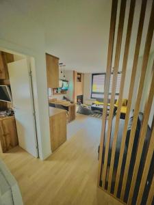 a kitchen and a living room with a refrigerator at Apartment Bjelasnica Dream in Bjelašnica