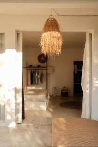 a room with a bed and a chandelier at VILLA MENORCA in Gili Trawangan