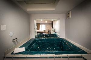 a large green bath tub in a bathroom at Envi Boutique Hotel in Henderson