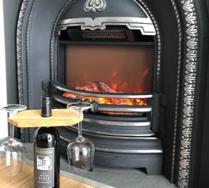 a fire place with a table in front of it at Vineyard Views Rutherglen in Rutherglen