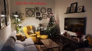 a living room with a christmas tree and a couch at Apartamentos Los Descalzos Free Parking in Ronda