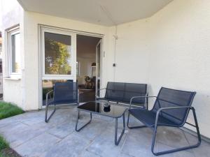 two chairs and a table on a patio at 85qm, 4 bedroom, parking, King-Bed, Wifi, Netflix in Waiblingen