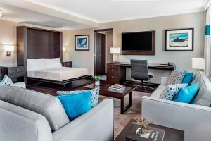 a hotel room with a bed and a living room at Four Points by Sheraton London in London
