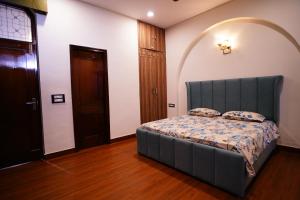 a bedroom with a bed in a room with a door at Madaan Villas in New Delhi