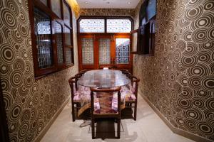 a dining room with a table and chairs at Madaan Villas in New Delhi