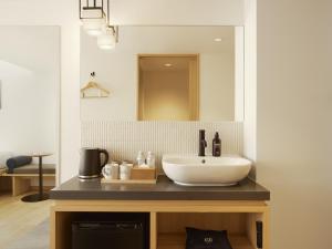 a bathroom with a sink and a mirror at ASAI Kyoto Shijo in Kyoto