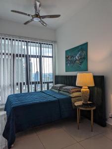 a bedroom with a bed and a ceiling fan at Legasi 3-bedroom condo - 5 mins walk to KLCC in Kuala Lumpur