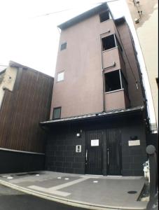 a building with its door open on a street at Guest House One More Heart Kyoto Station South 4 in Kyoto