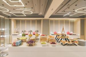 a restaurant with a buffet of food on display at Atour Hotel East Nanjing Road Near The Bund in Shanghai