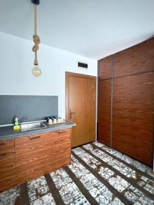 a kitchen with a sink and a wooden door at Blue Apartment Pirin Golf & Spa in Bansko