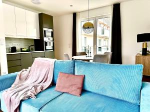 a blue couch with a blanket on it in a kitchen at Central Apartment Budapest ~ Roof Terrace/AC/Indoor parking in Budapest