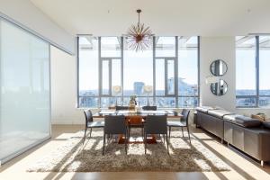 a dining room with a table and chairs and a couch at LuxeStay in Vancouver