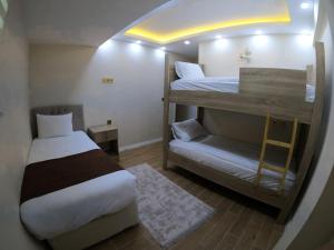 UZUNGÖL ADİLOGLU SUIT في أوزونغول: غرفة صغيرة مع سريرين بطابقين وسلم
