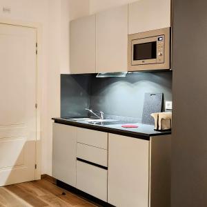 a kitchen with a sink and a microwave at b&b marconi 49 in Bologna