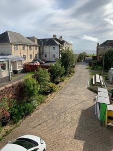 a street with houses and a car parked on a sidewalk at At The Beach in Stevenston