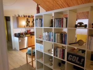 a book shelf filled with books in a kitchen at AVD - Residence Palma in Udine