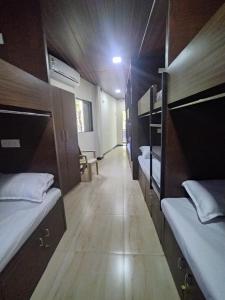 a hallway of a dorm room with bunk beds at DC Dormitory Asalpha Metro in Mumbai
