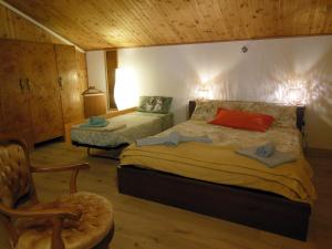 a bedroom with a bed and a chair in a room at AVD - Residence Palma in Udine