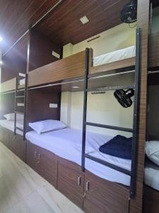 a room with two bunk beds in a building at DC Dormitory Asalpha Metro in Mumbai