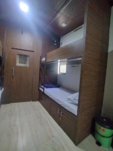 a small room with a bunk bed on a boat at DC Dormitory Asalpha Metro in Mumbai