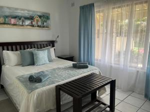 a bedroom with a bed with towels on it at Villa Del Sol Unit 8 in Margate