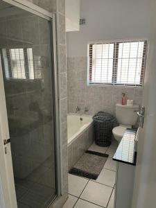 a bathroom with a shower and a toilet at Villa Del Sol Unit 8 in Margate