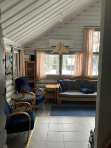 a living room with a couch and chairs at Rukavalo Cottage in Ruka