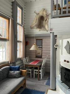 a living room with a table and a couch at Rukavalo Cottage in Ruka