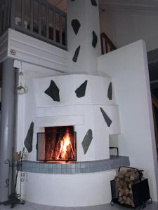 a brick oven with a fire in it at Rukavalo Cottage in Ruka