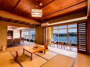 a living room with a view of the water at Yukai Resort Premium Shirahama Saichoraku in Shirahama