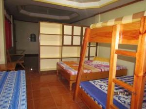 a bedroom with two bunk beds in a room at TRIPLE JS INN-SAGADA in Sagada