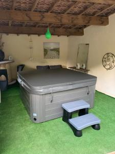 a room with a large bed and two stools at La bulle étoile in Allegre Les Fumades