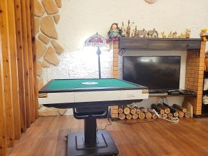a ping pong table in a living room with a pool table at British Country Inn B&B in Luodong