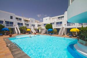 a large swimming pool in front of a building at San Francisco Park in Puerto del Carmen