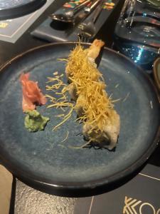 a plate of food with noodles on a table at PRESIDENCY AIRPORT HOTEL in Cochin
