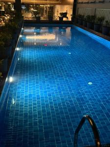 a swimming pool with blue tiles in a building at PRESIDENCY AIRPORT HOTEL in Cochin