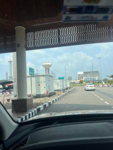 a car driving down a road with a gas station at PRESIDENCY AIRPORT HOTEL in Cochin