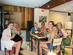a group of women sitting at a table at ALPHA Hostel Cafe&Bar in Ao Nang Beach