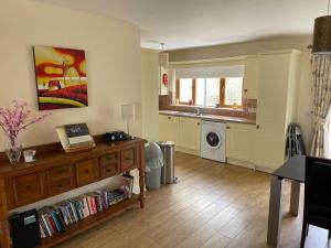 a living room with a sink and a washing machine at Lough Rynn Rental in Mohill