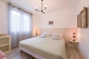 1 dormitorio con 1 cama con 2 almohadas y ventana en Les Gîtes de Nathalie: Corneille et Rivals en Carcassonne