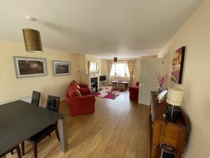 a living room with a red couch and a table at Lough Rynn Rental in Mohill
