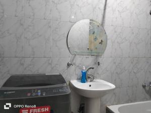 a small bathroom with a sink and a mirror at Cozy apartment Maadi Ring road in Cairo
