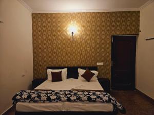 a bedroom with a bed with pillows on it at Raj Residency Inn in Gurgaon