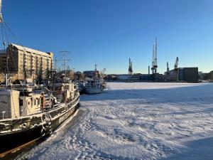 Un par de barcos atracados en un cuerpo de agua en Cosy flat in the heart of Helsinki center, en Helsinki