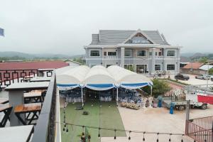 a large building with umbrellas in front of it at Tulip Hotel in Louang Namtha