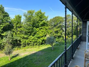 a balcony with a view of a garden at Luxury garden flat under the Castle in Kent