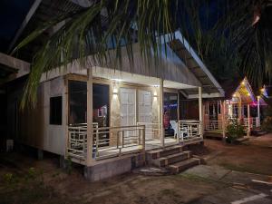 a small house with a porch at night at Tamara Guest House in Tioman Island